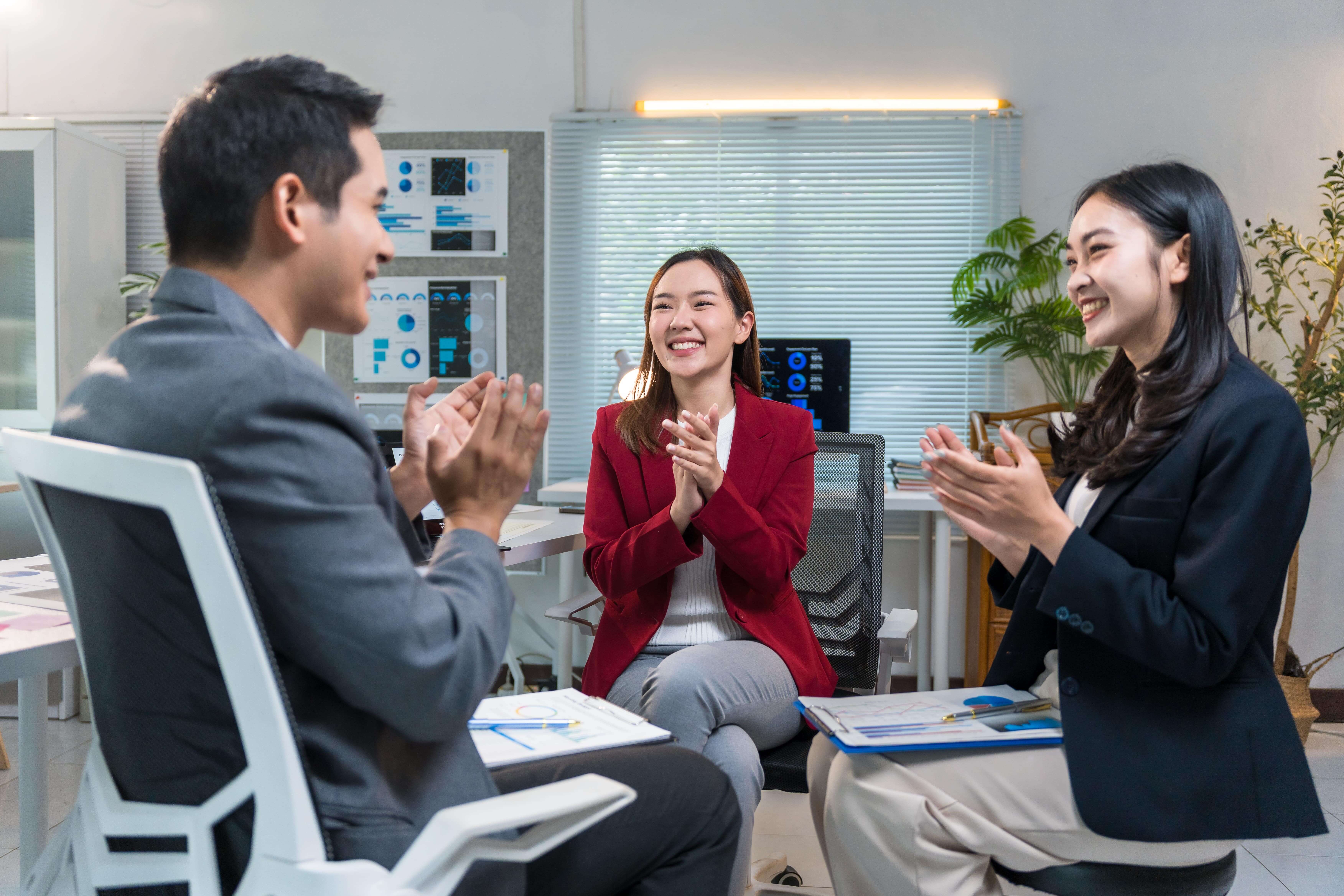 business team clapping hands during a meeting