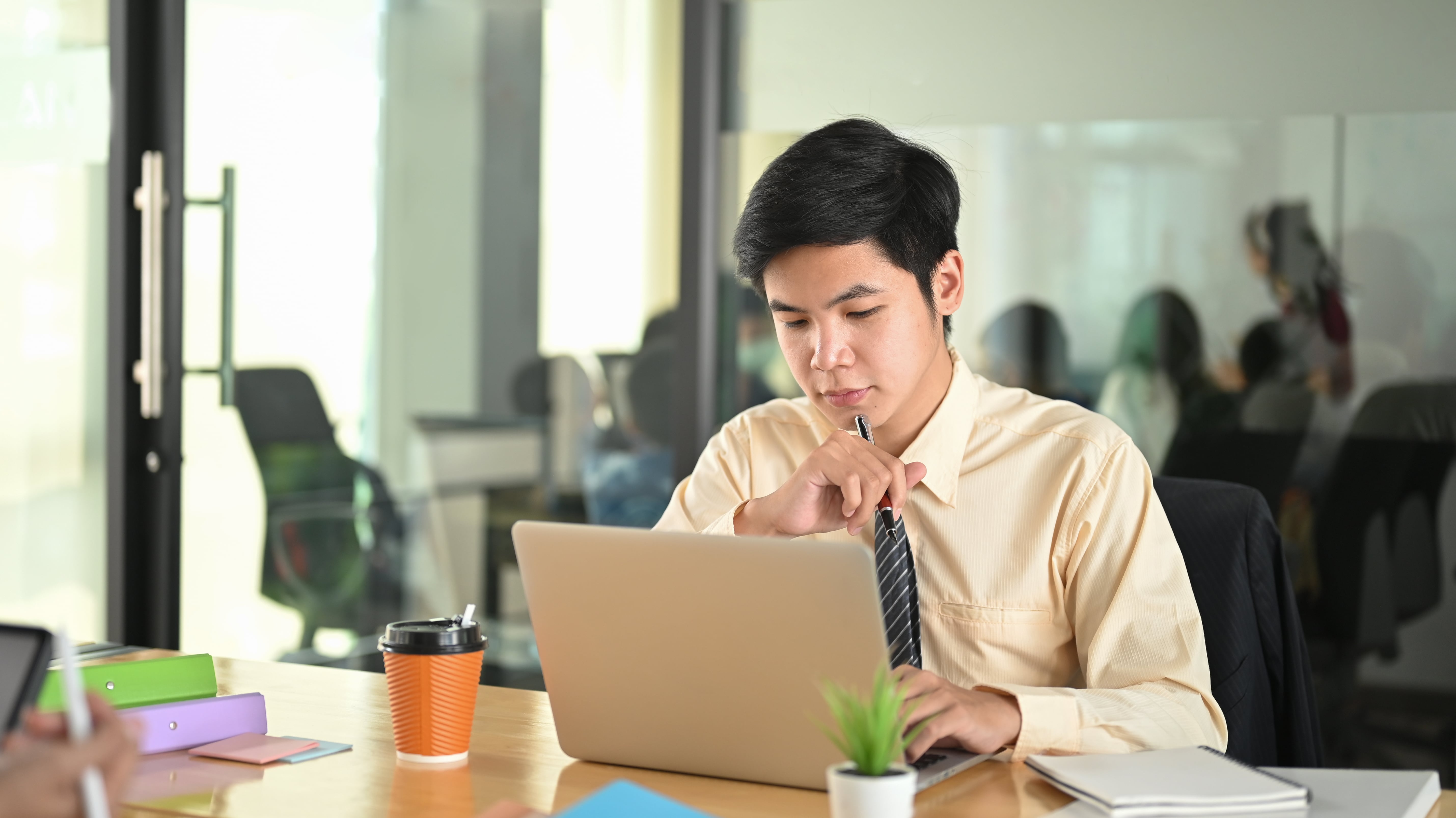 a-businessman-is-using-a-computer-laptop-while-sitting