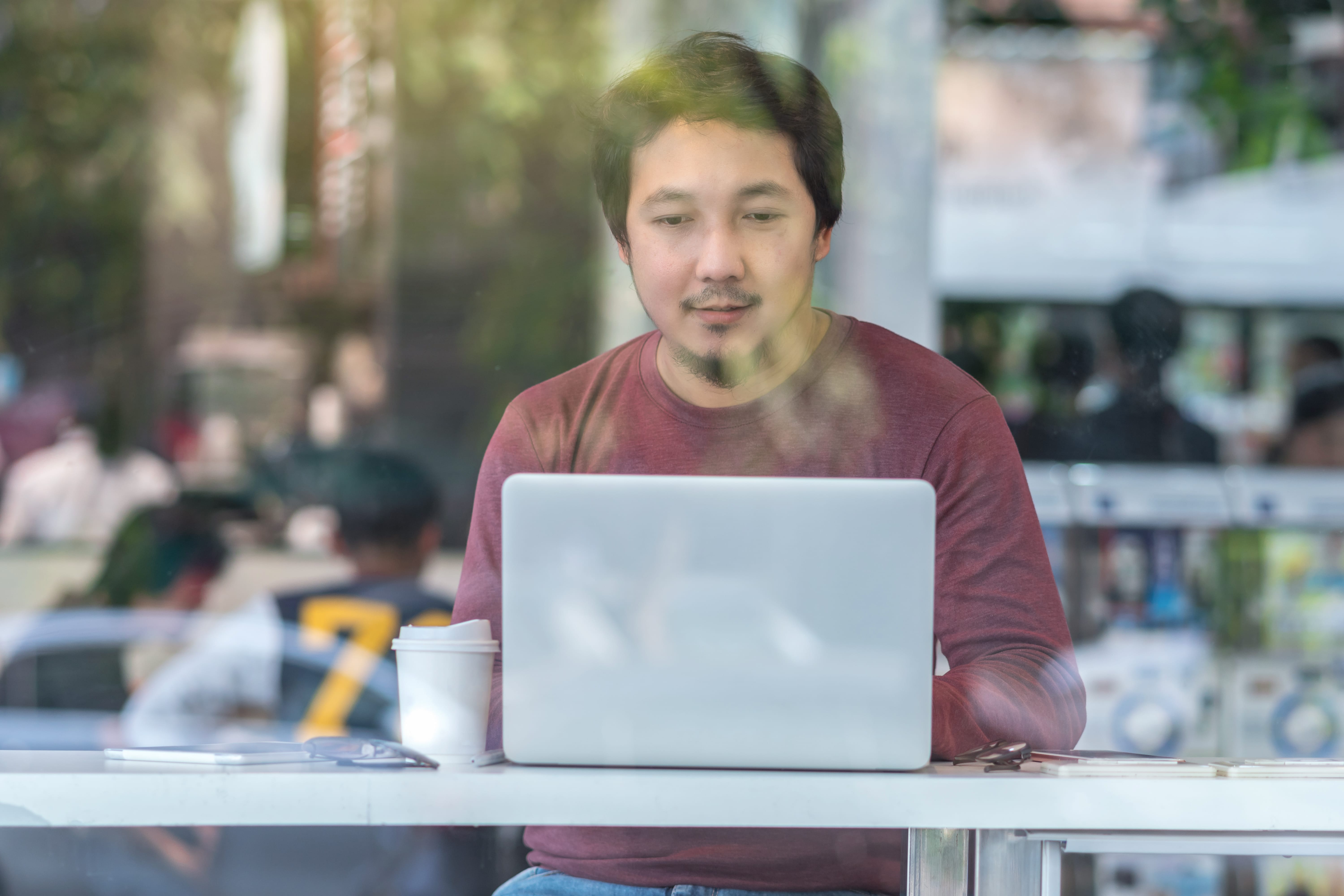 portrait-of-asian-businessman-in-casual-suit-using-laptop