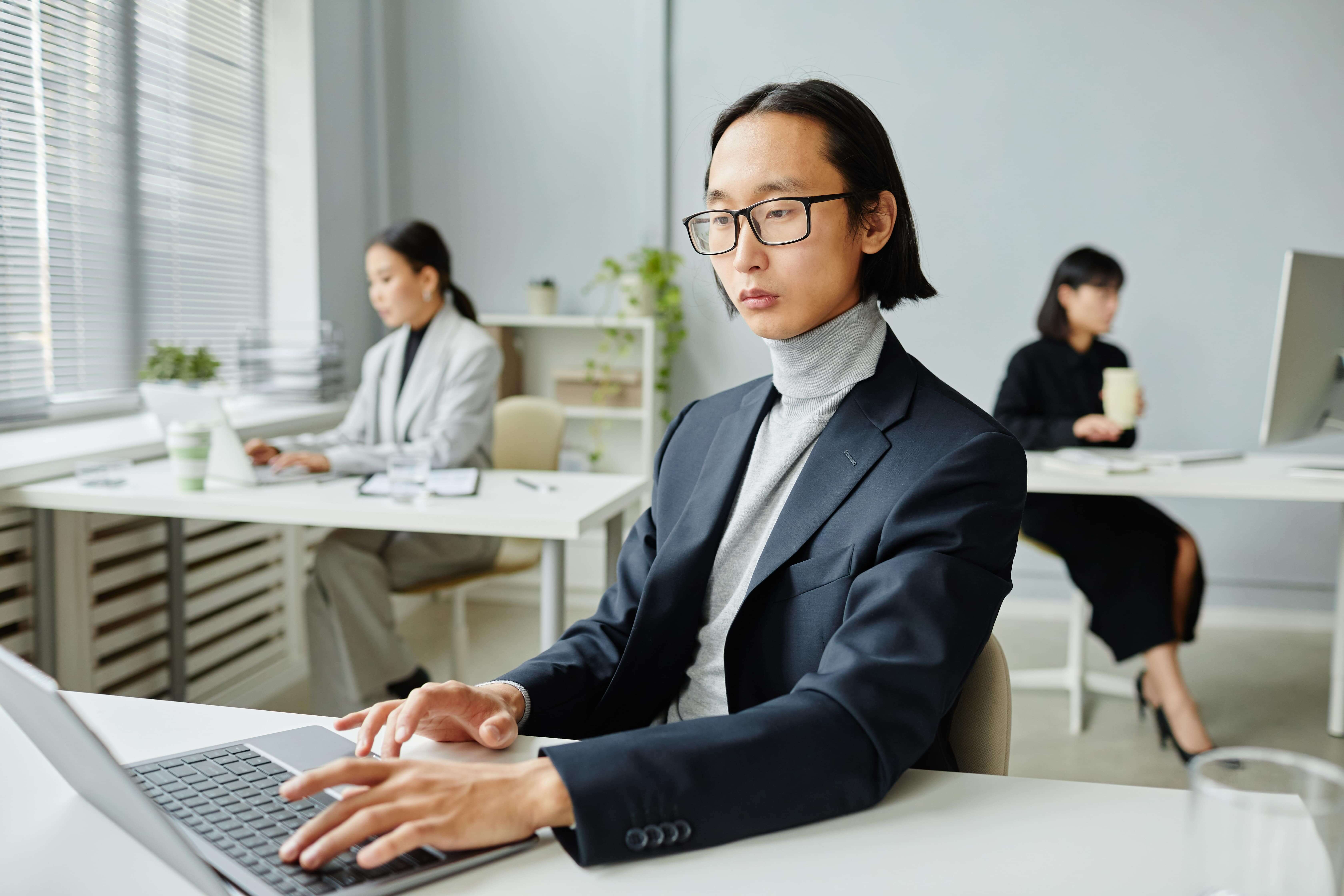 serious asian employee entrepreneur working