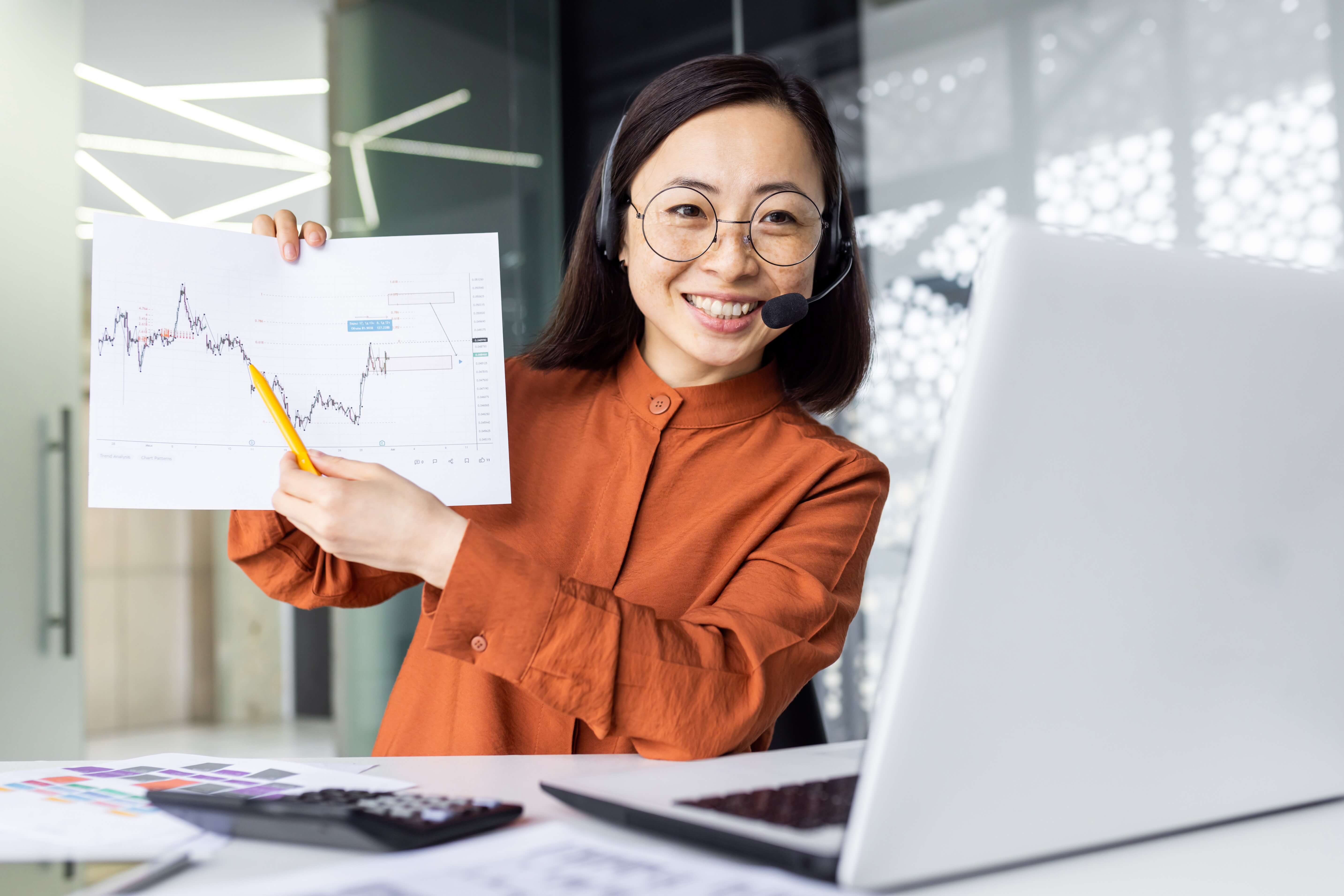 online-presentation-remote-meeting-asian-woman-with-headset-phone-smiling-and-showing-to-laptop