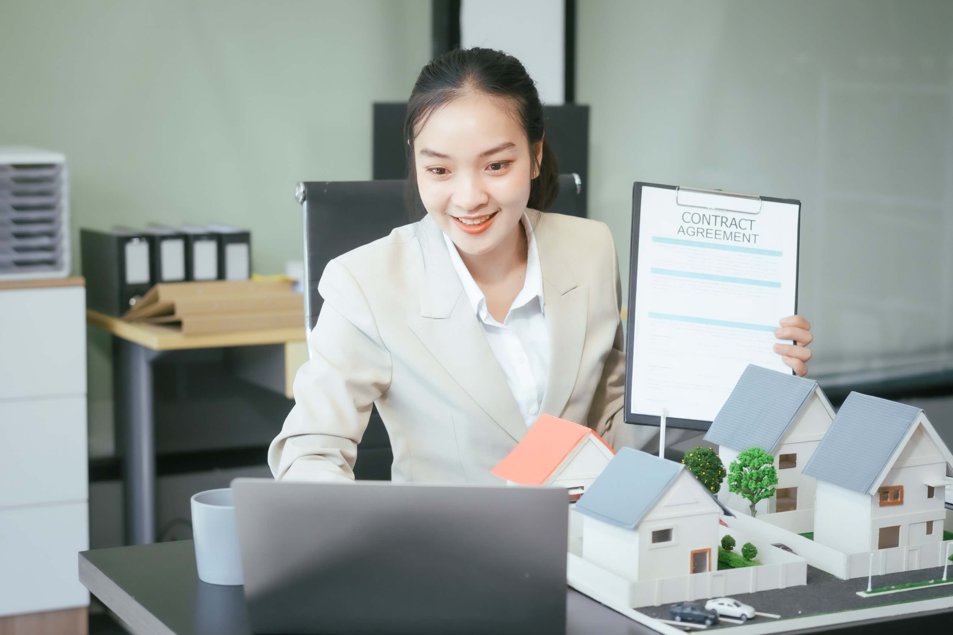 asian female staff member sells houses online, discussing project homes, loans, and contracts