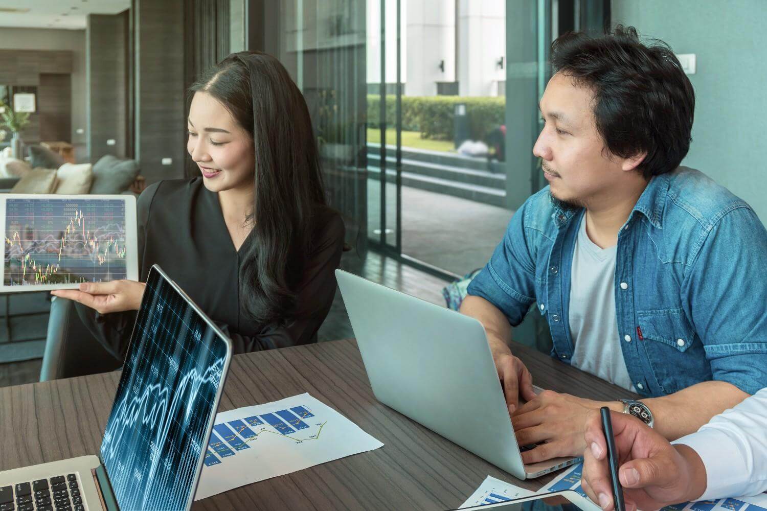 Business analysts reviewing stock market charts