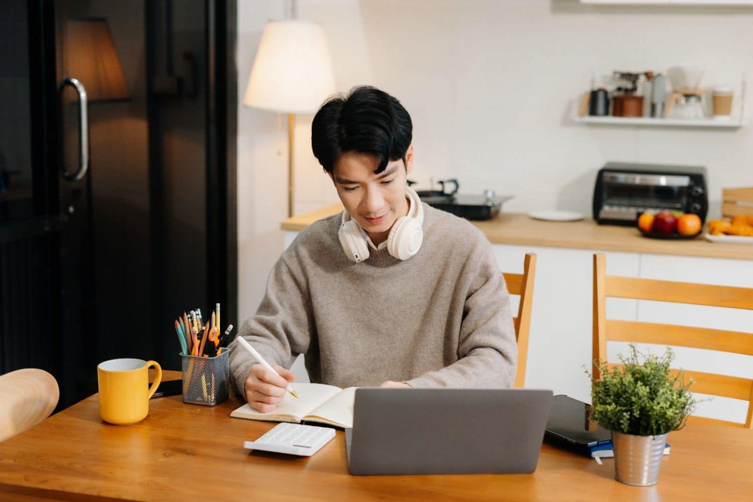 modern-home-office-setup-with-freelancer-writing-during-remote-meeting.jpg