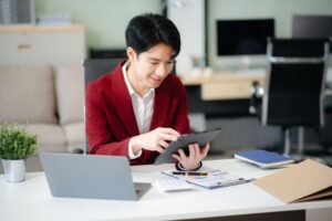 businessman-reviewing-financial-spreadsheets-with-laptop-and-tablet.jpg