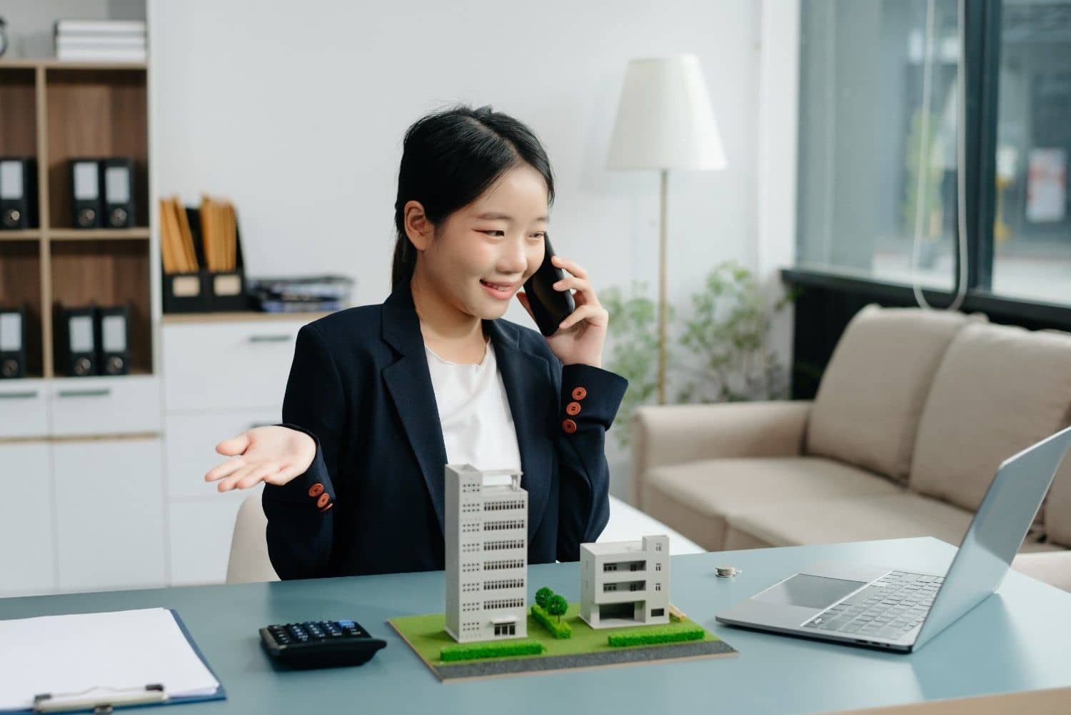 Real estate agent working on a laptop at a desk