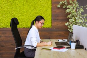 Virtual assistant working at desk living wall