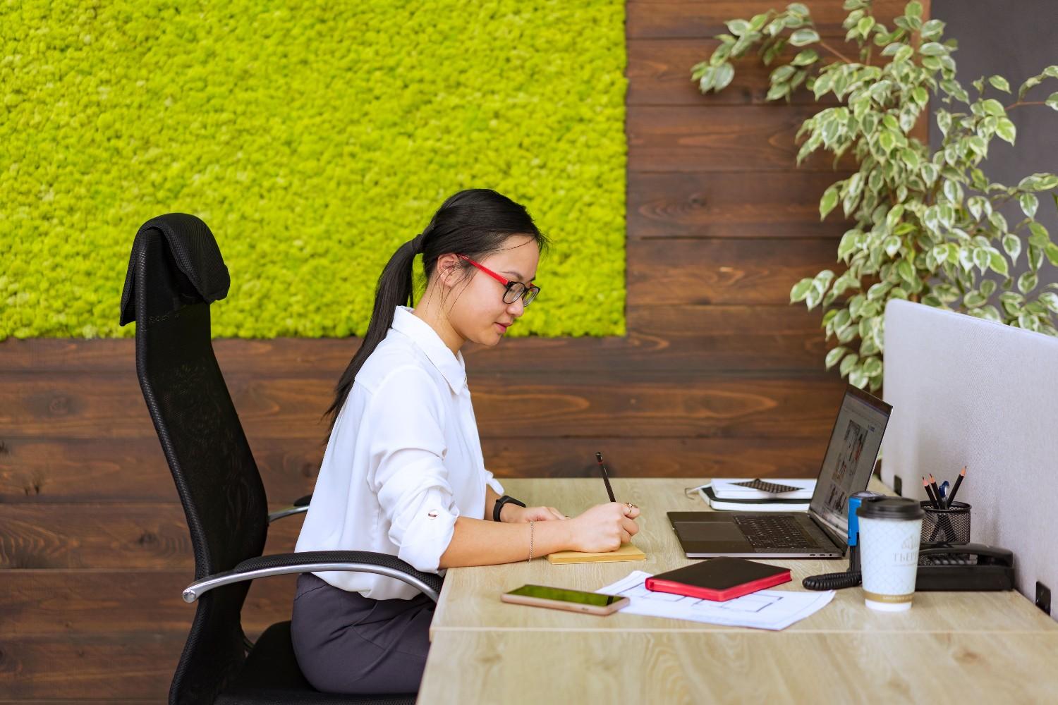 Virtual assistant working at desk living wall