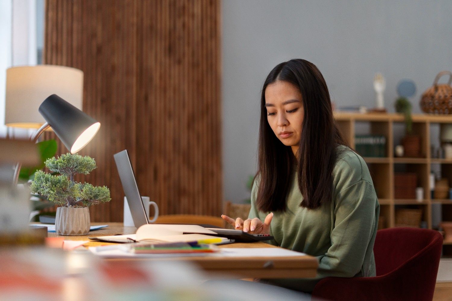 Remote bookkeeper virtual assistant calculating expenses