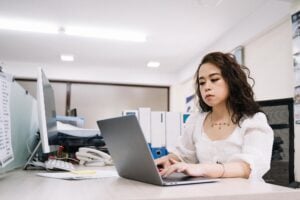 Corporate woman typing laptop office desk