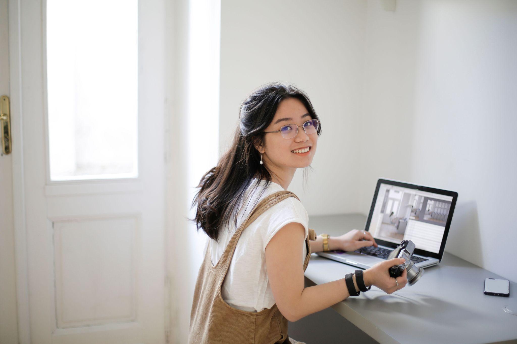 Freelance photographer editing photos laptop