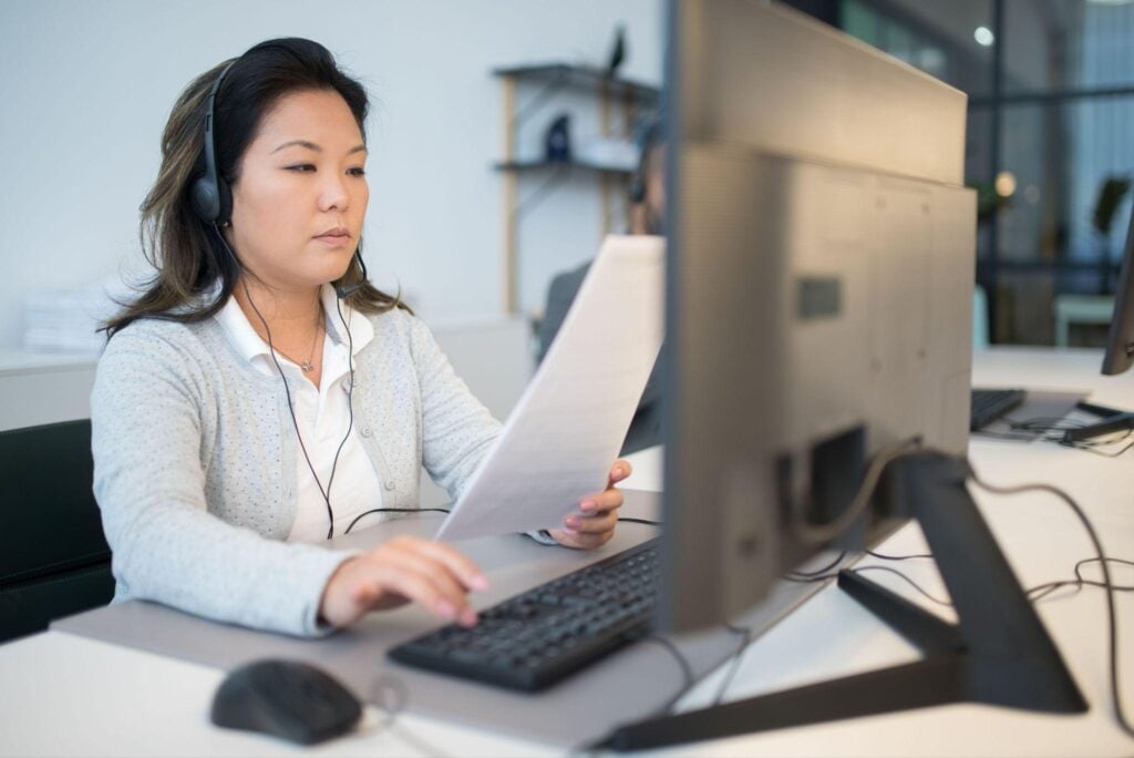 Customer support agent reviewing document