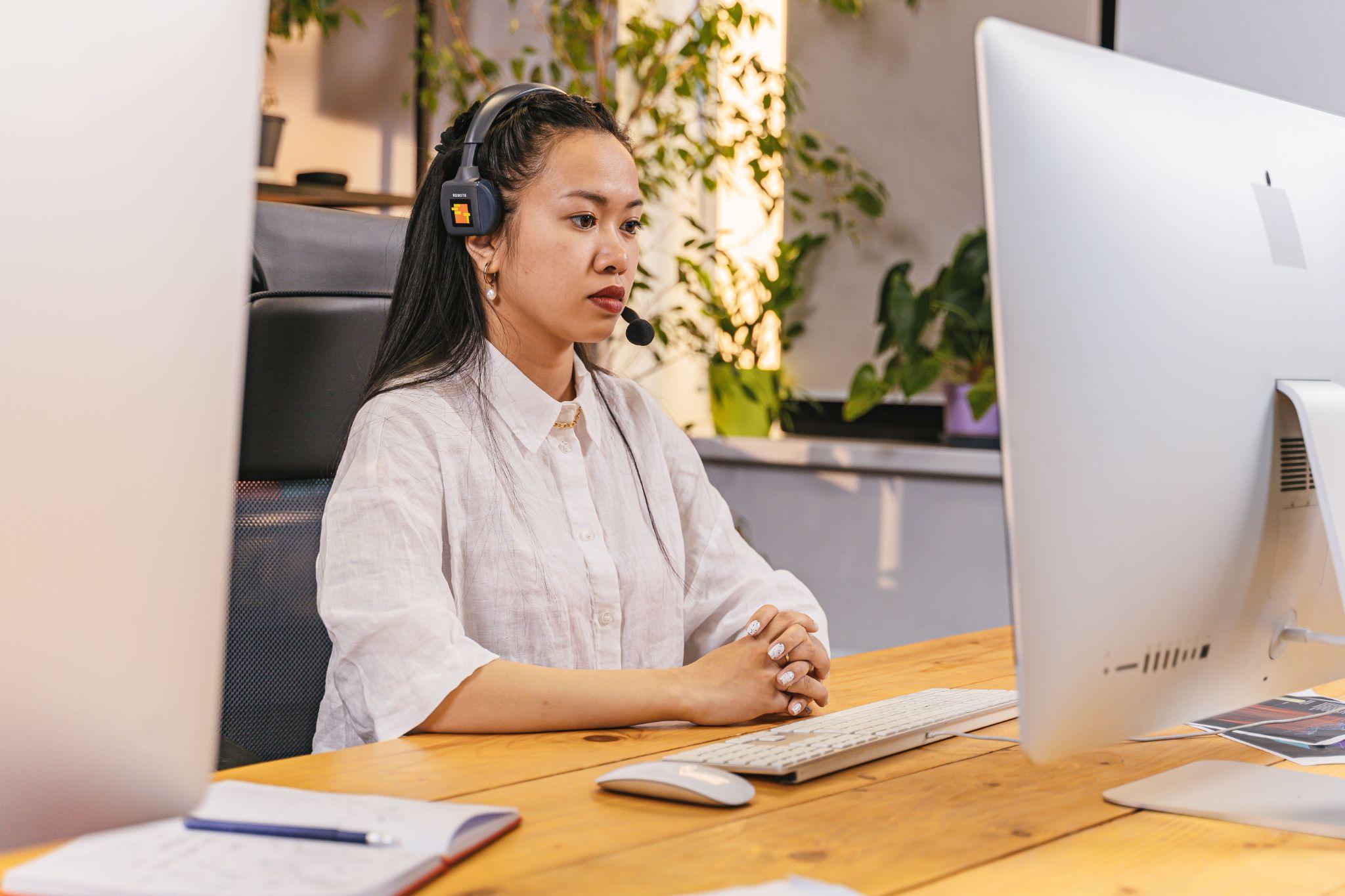Female virtual assistant headset office desk