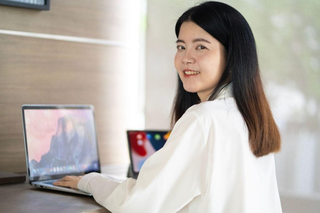 Smiling remote worker laptop home office
