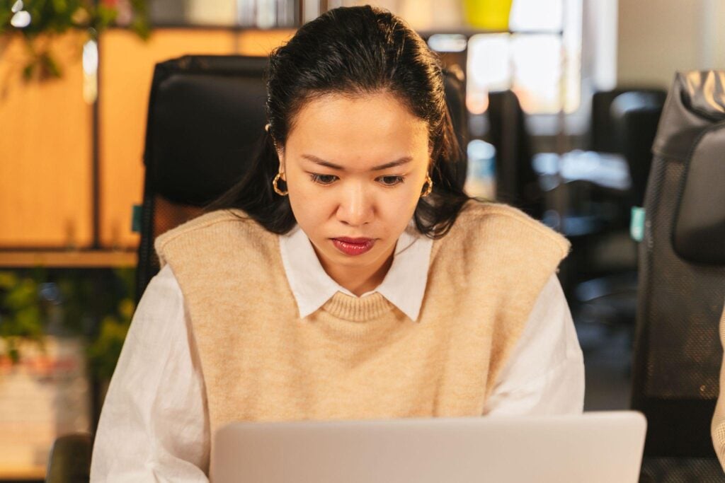 Focused female professional working laptop