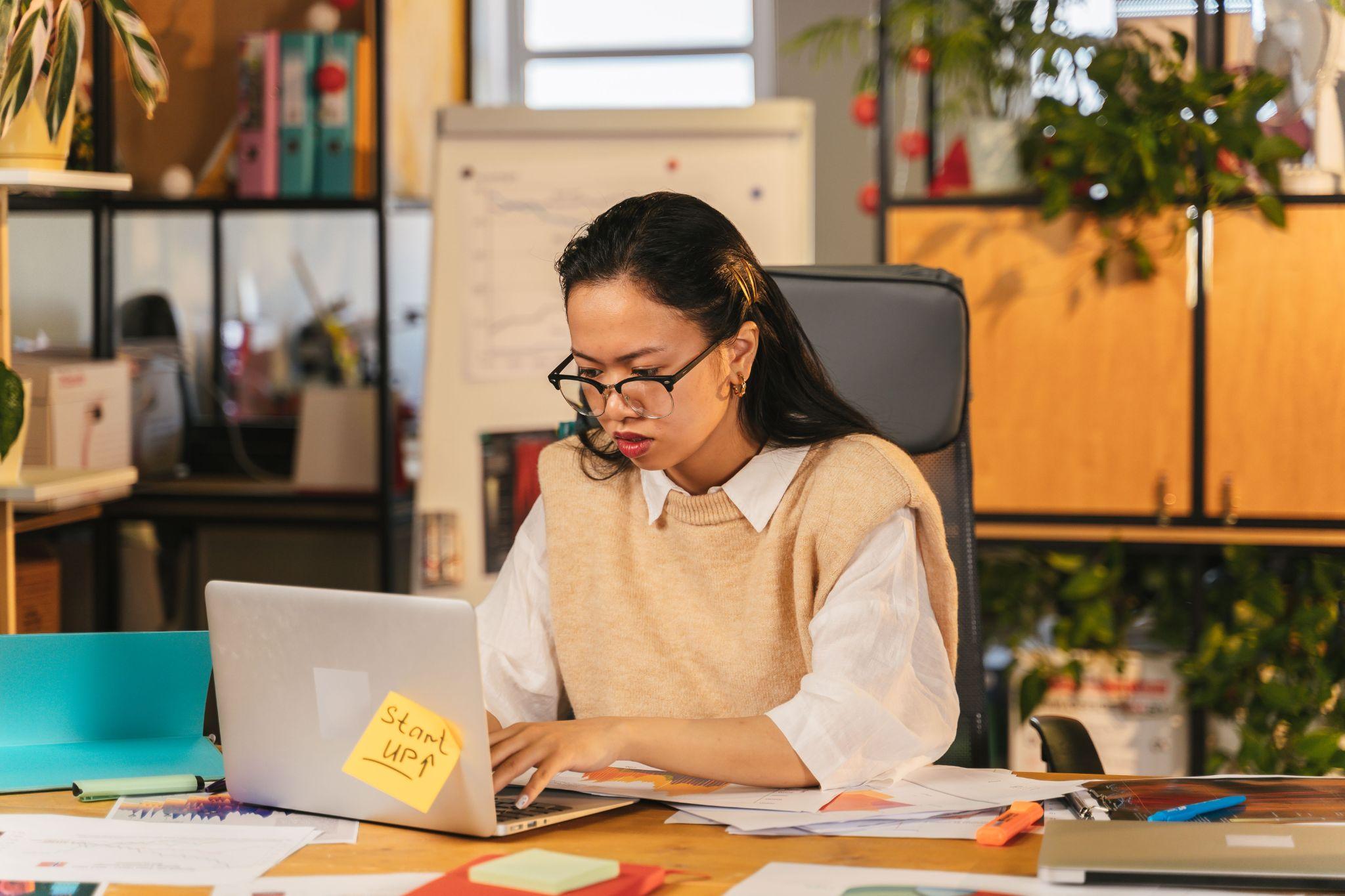 Focused female professional working laptop