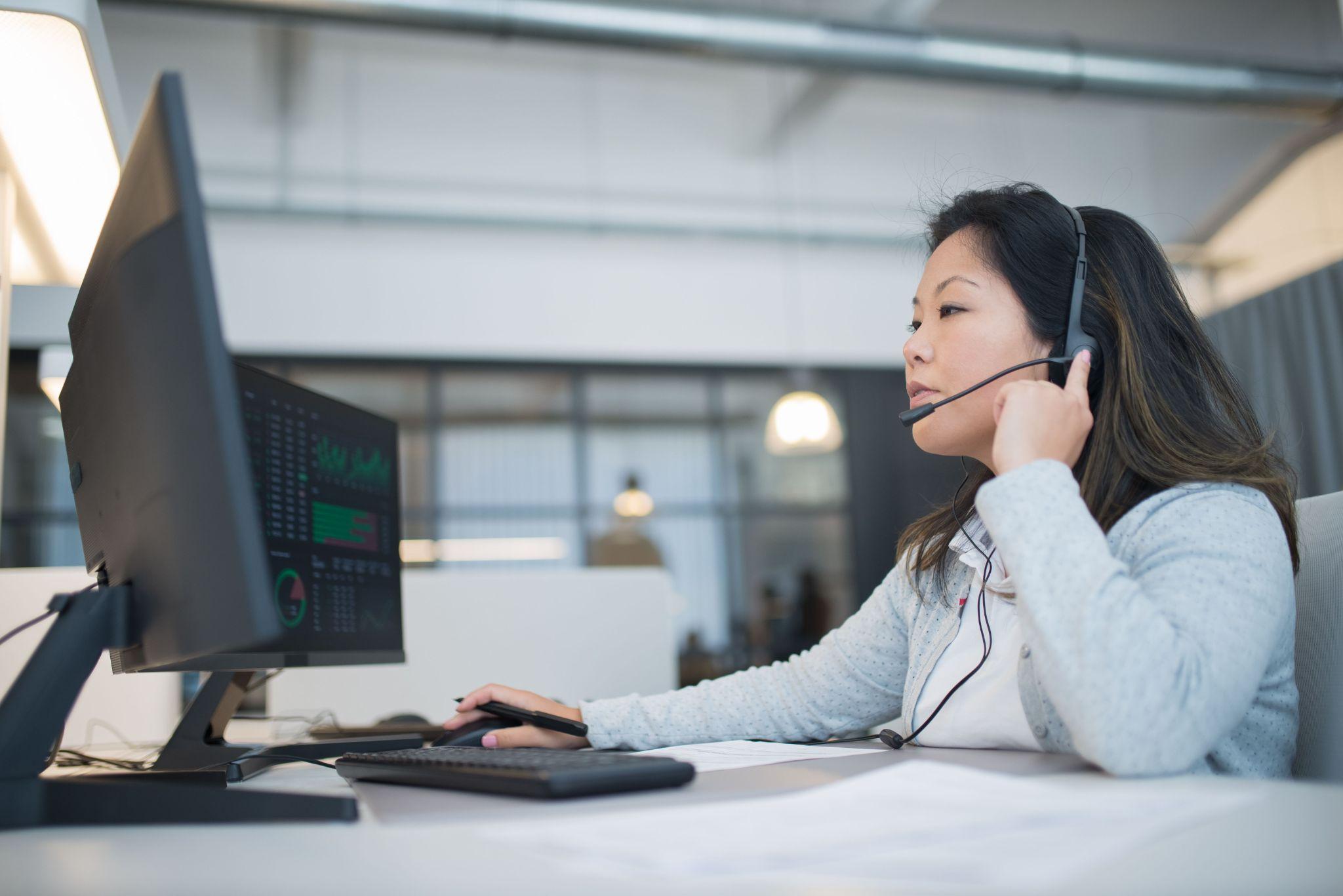 Call center agent adjusting headset desk