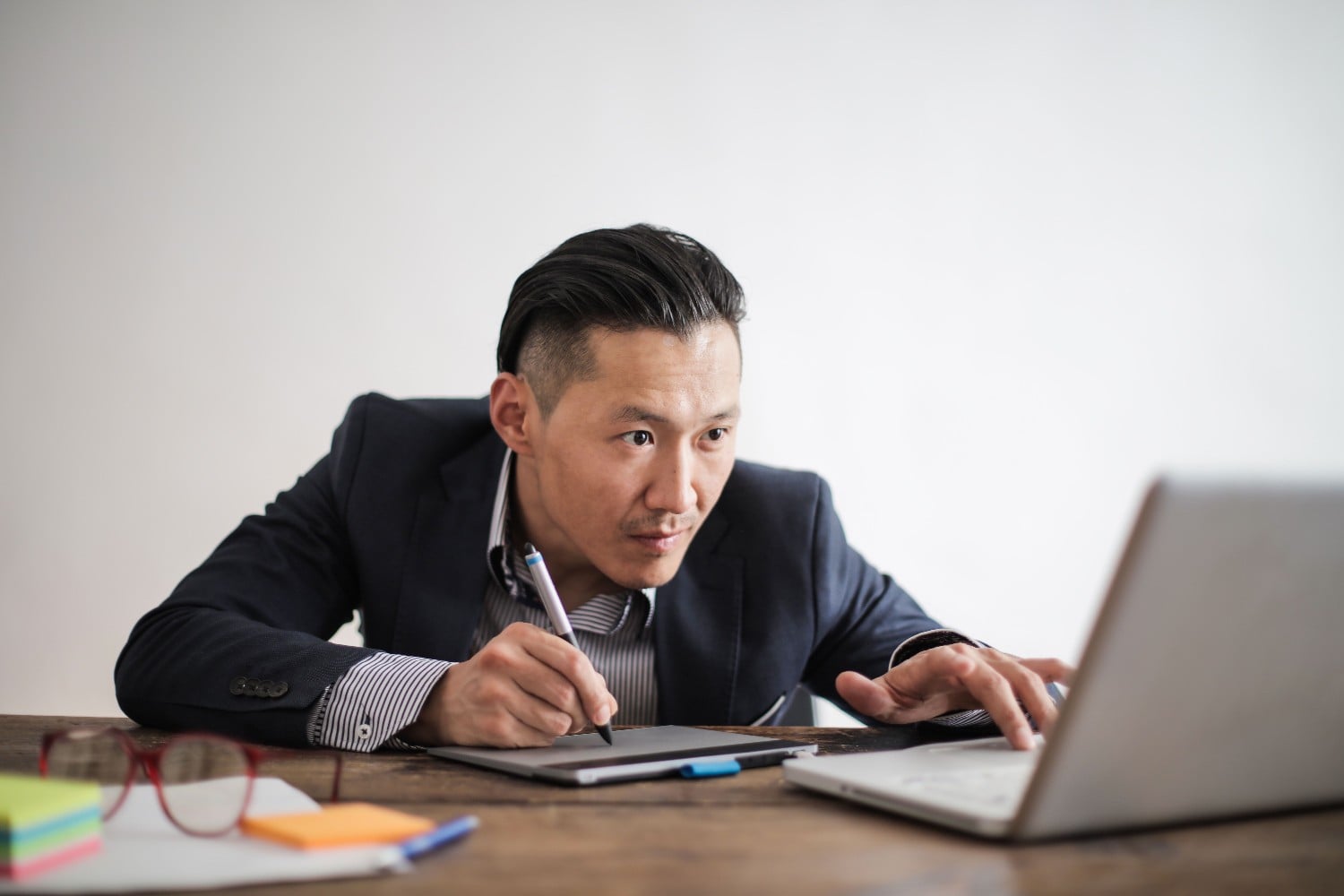 Asian creative director editing on laptop