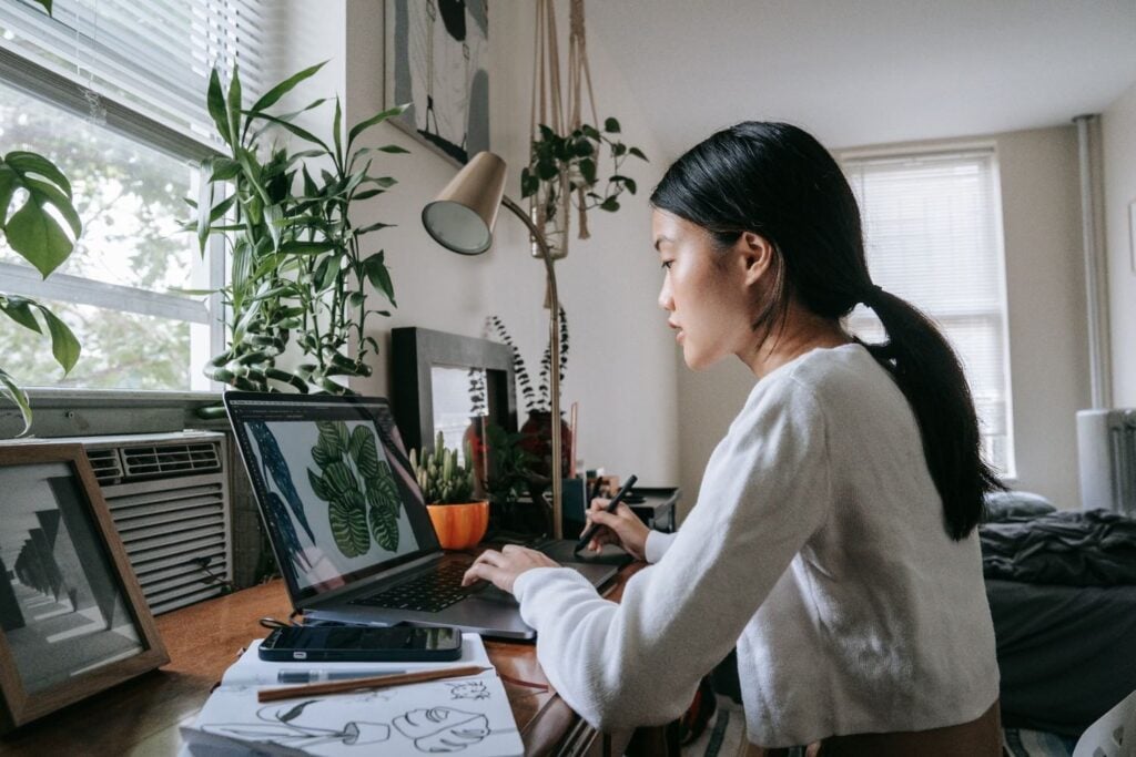 Freelance graphic designer working near window