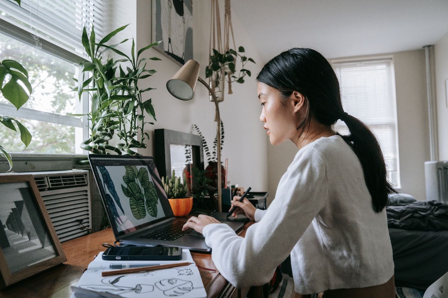 Freelance graphic designer working near window