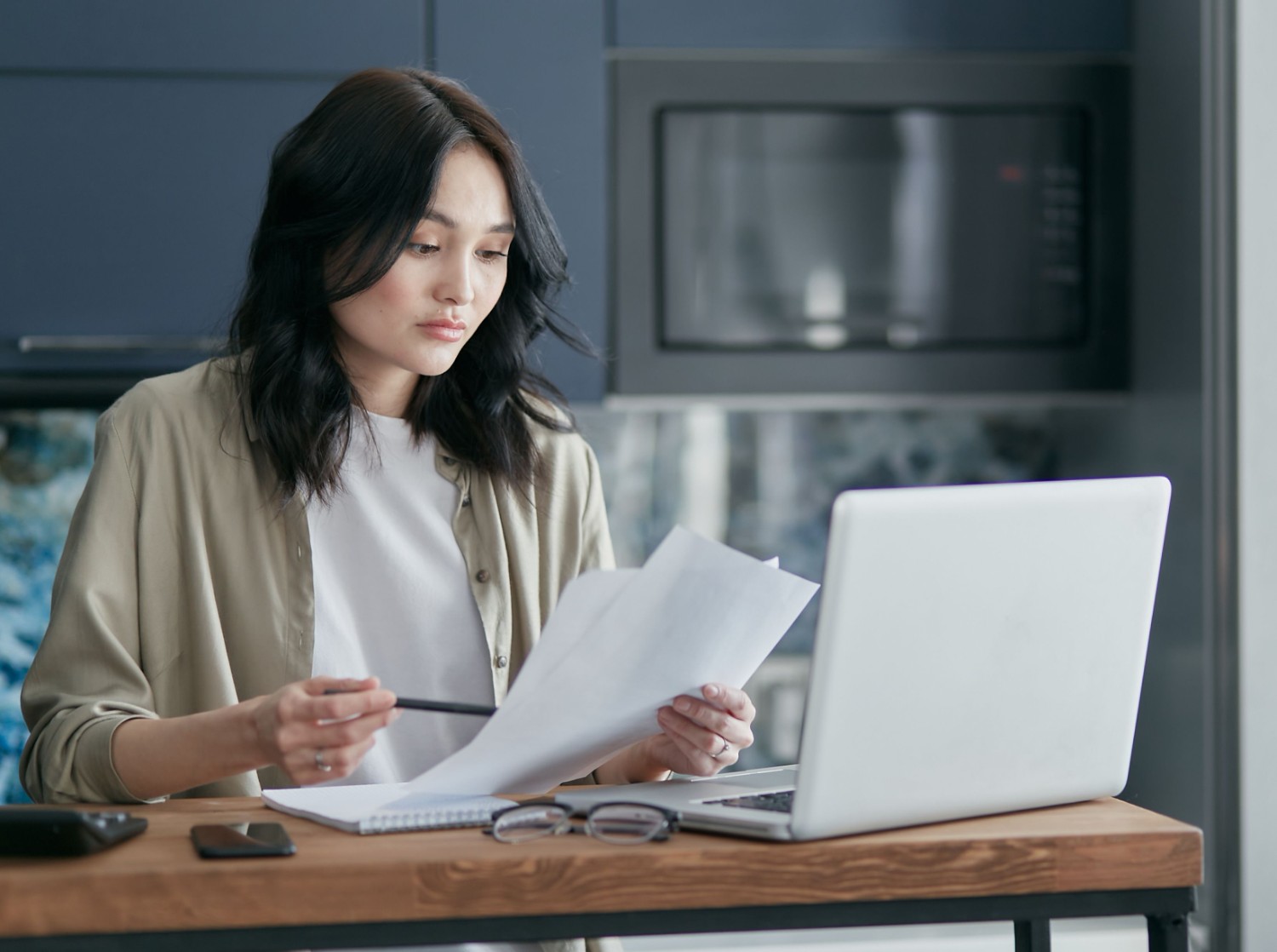 Remote bookkeeper working on laptop at home