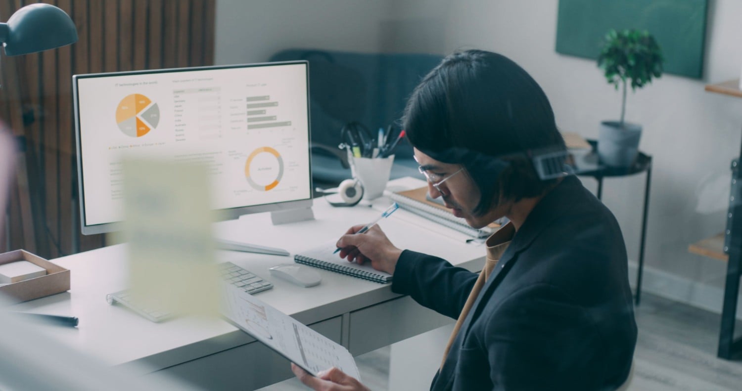 Financial analyst reviewing charts on monitor
