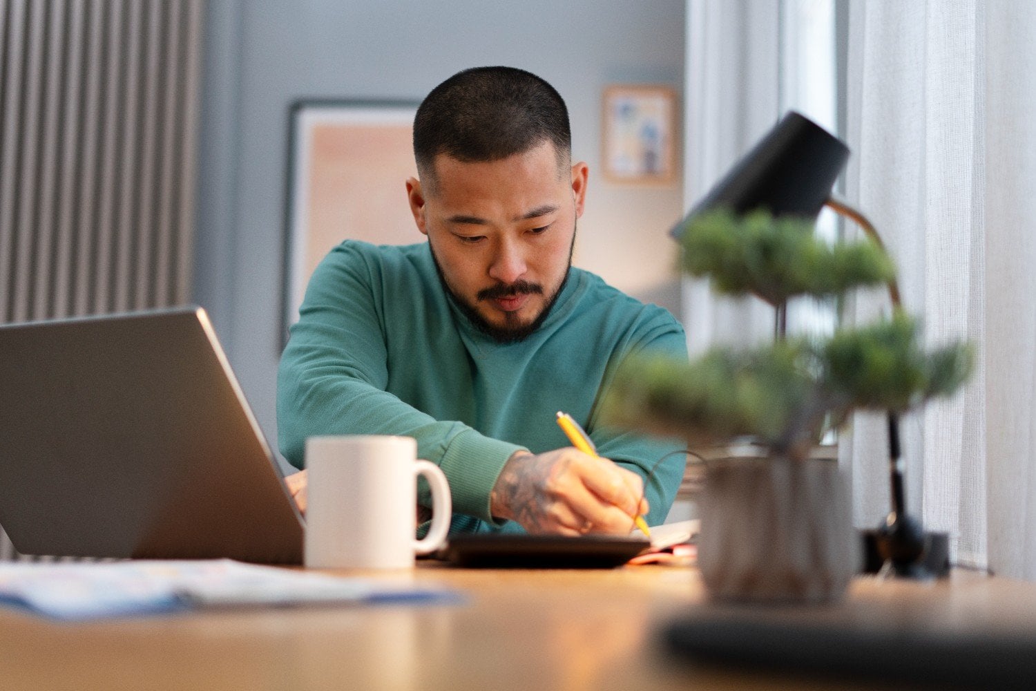 Business owner working through decisions at his home office desk