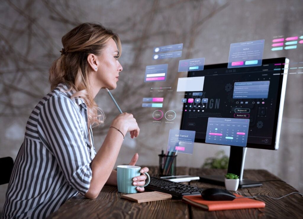 Woman reviewing account settings and permission screens on a desktop monitor
